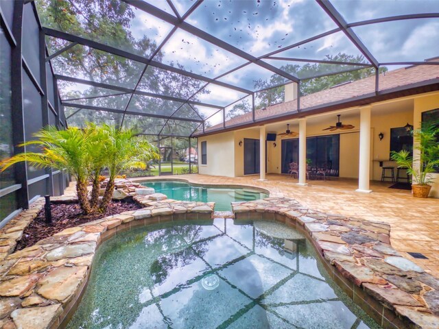 view of pool with a lanai, a patio area, and ceiling fan