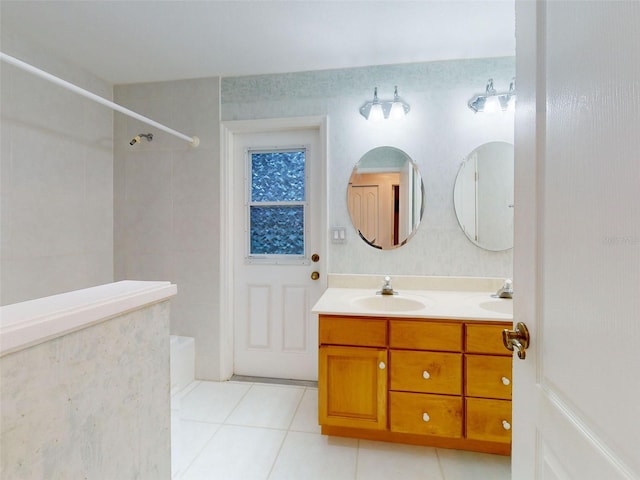 bathroom featuring tile patterned flooring, vanity, and tiled shower / bath combo