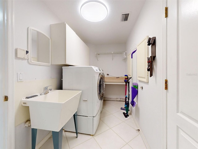 laundry room with washer / dryer, sink, and light tile patterned flooring