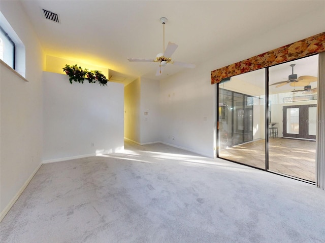 carpeted spare room with ceiling fan