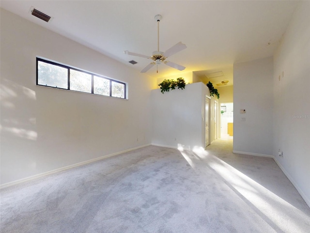 carpeted spare room featuring ceiling fan