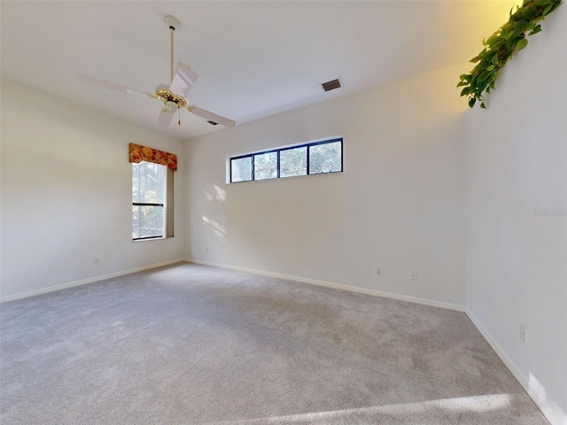 unfurnished room with light colored carpet and ceiling fan