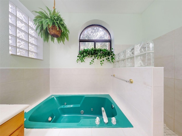 bathroom with a washtub and vanity