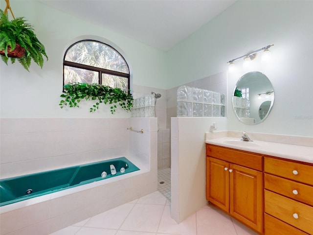 bathroom featuring tile patterned flooring, vanity, and plus walk in shower