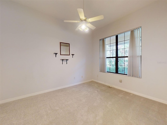 carpeted empty room with ceiling fan