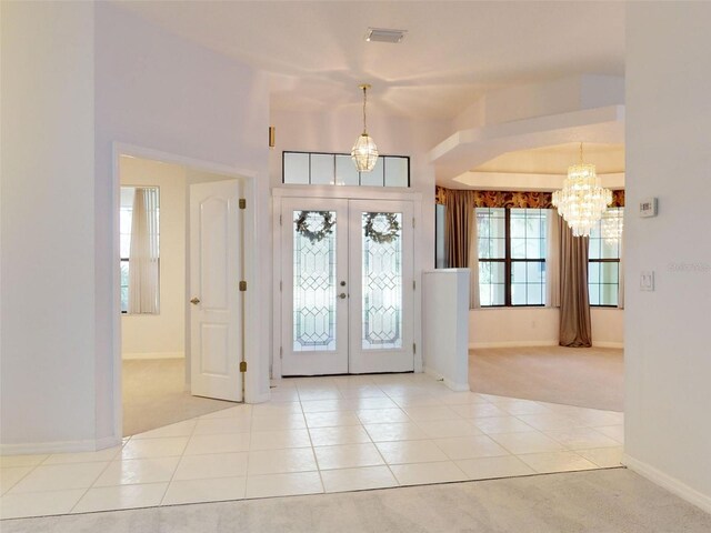 1780 Otisco Way, Winter Springs, FL 32708 - foyer entrance with a chandelier, carpet flooring, baseboards, tile patterned floors, and french doors
