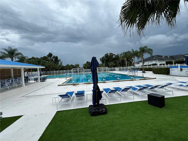 view of swimming pool with a yard and a patio