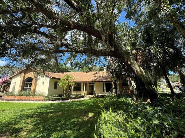 1780 Otisco Way, Winter Springs, FL 32708 - view of front of property with stucco siding and a front lawn
