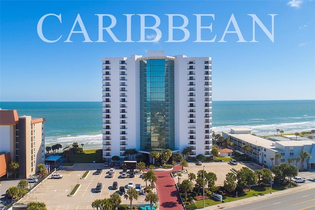 exterior space with a water view and a view of the beach