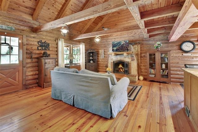 living area with hardwood / wood-style flooring, a fireplace, and high vaulted ceiling