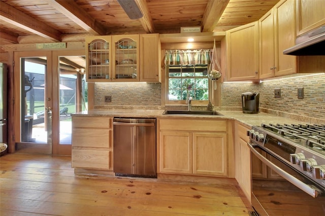 kitchen with stainless steel appliances, light brown cabinets, a sink, and under cabinet range hood