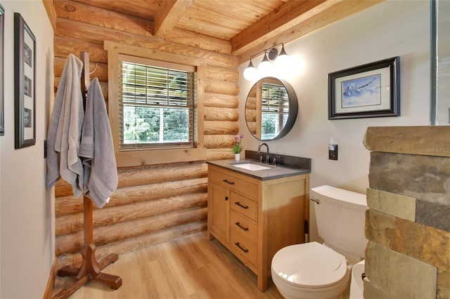 bathroom featuring beam ceiling, toilet, vanity, wood finished floors, and wooden ceiling