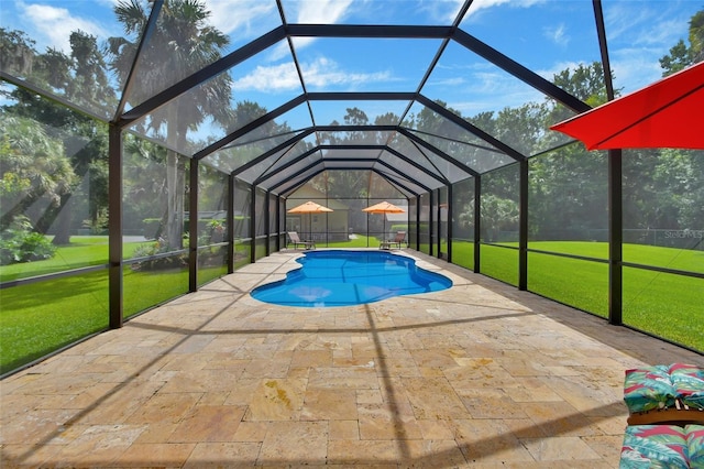 pool with a yard, a patio area, and a lanai