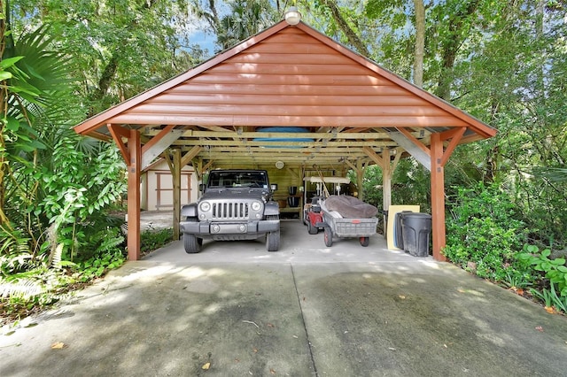 view of parking / parking lot with driveway, a shed, and a detached carport