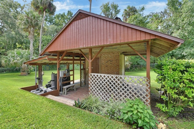 view of community with a lawn and fence