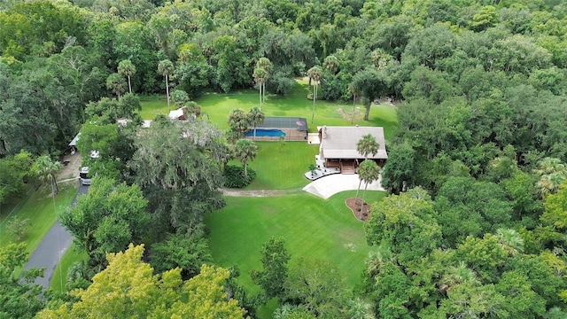 drone / aerial view featuring a view of trees