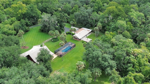 birds eye view of property featuring a view of trees