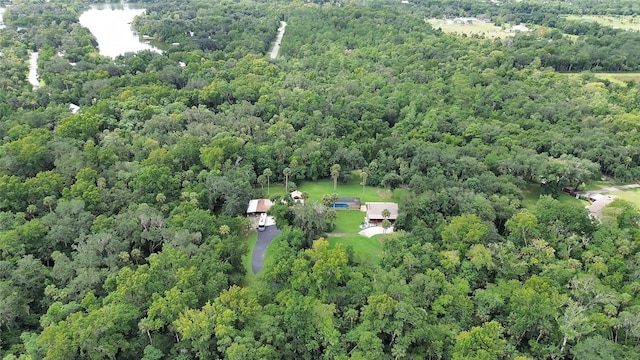 birds eye view of property with a forest view