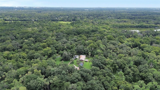 birds eye view of property with a view of trees