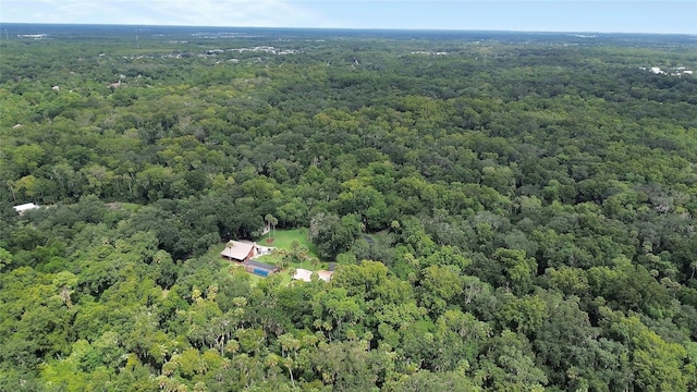 birds eye view of property featuring a wooded view