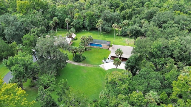 bird's eye view with a wooded view