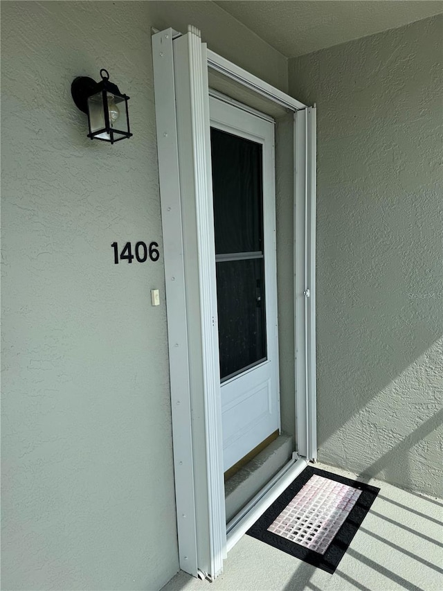 property entrance with stucco siding