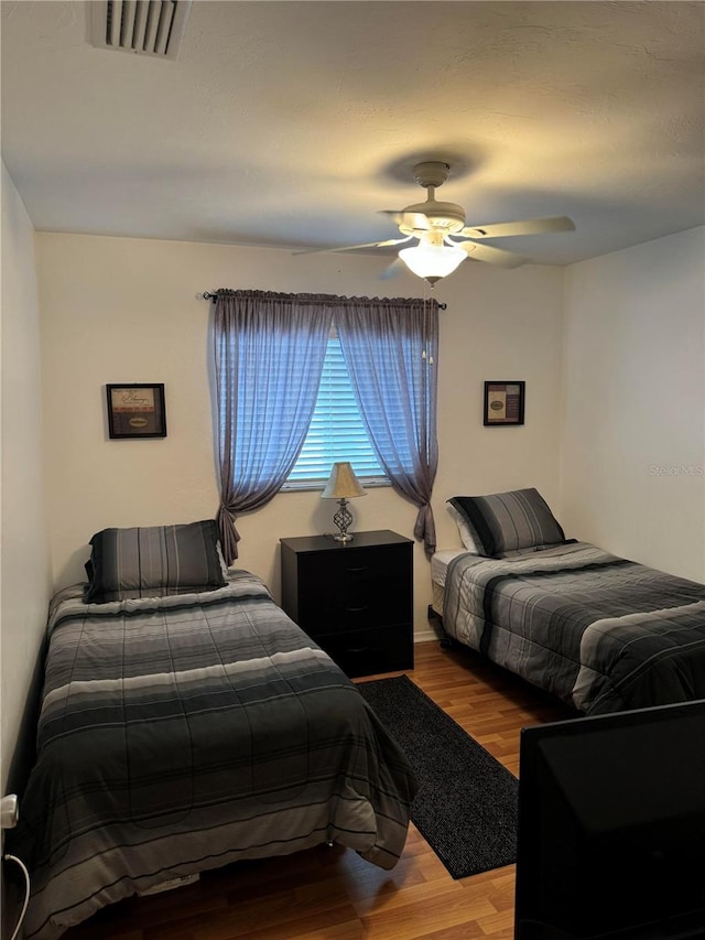 bedroom with ceiling fan and hardwood / wood-style floors