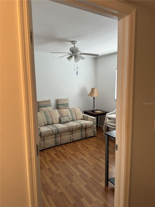 living room with ceiling fan and wood-type flooring