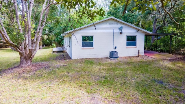 view of property exterior featuring a yard and central AC