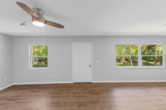 spare room with ceiling fan and wood-type flooring