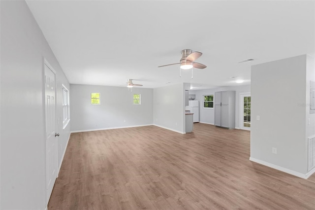 unfurnished living room with ceiling fan and light wood-type flooring