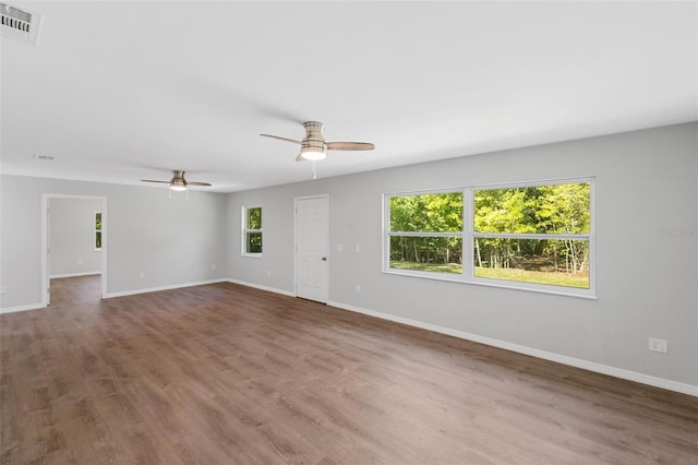 unfurnished room with wood-type flooring, plenty of natural light, and ceiling fan