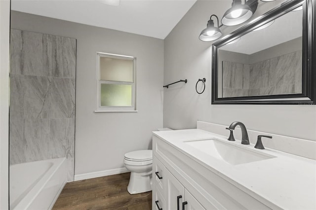 full bathroom with hardwood / wood-style floors, vanity, toilet, and washtub / shower combination