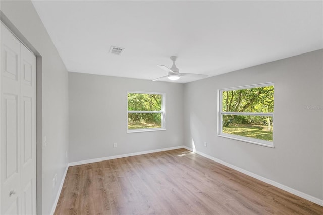 unfurnished room with ceiling fan and light hardwood / wood-style flooring