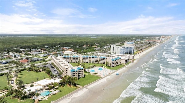 drone / aerial view featuring a beach view and a water view