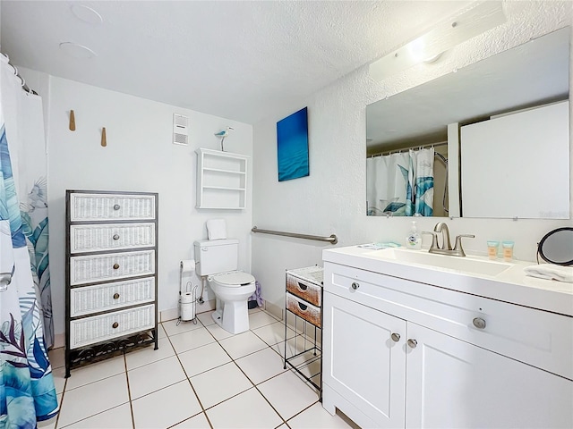 bathroom featuring tile patterned floors, toilet, a textured ceiling, and vanity