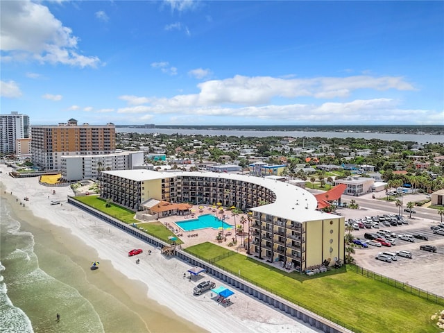 bird's eye view featuring a water view and a beach view