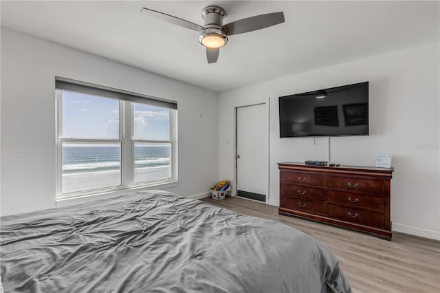 bedroom featuring ceiling fan, wood finished floors, and baseboards