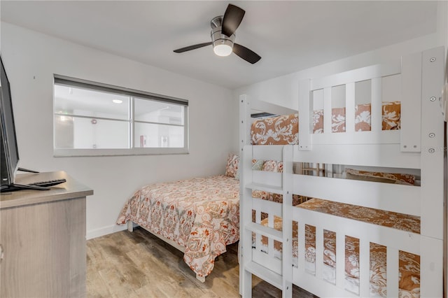 bedroom featuring light wood-type flooring, ceiling fan, and baseboards