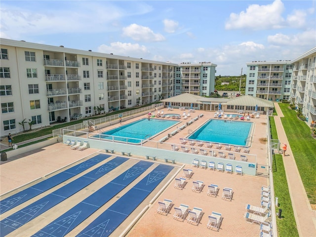 pool featuring fence, a gazebo, and shuffleboard