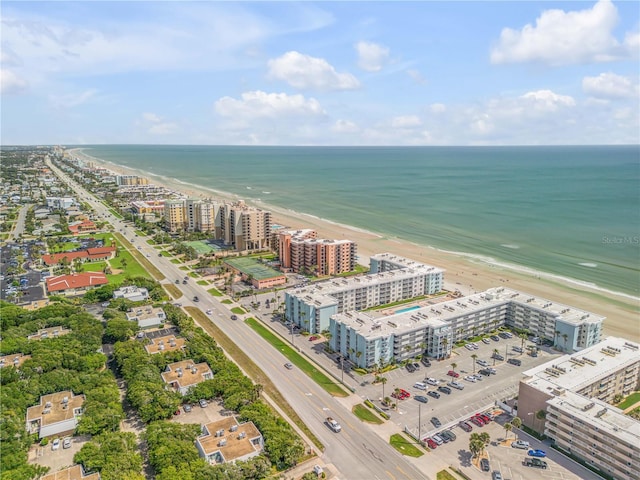 aerial view featuring a water view, a view of city, and a beach view