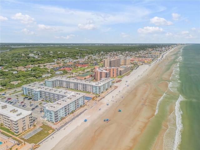 birds eye view of property with a view of city, a water view, and a beach view