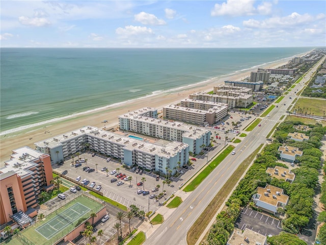 aerial view featuring a water view, a beach view, and a city view