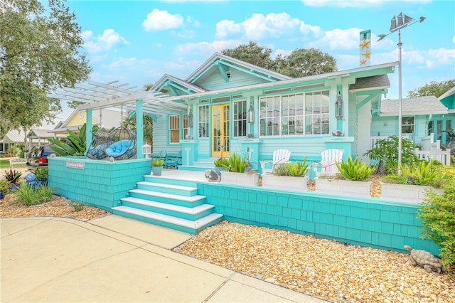 view of front of house with french doors and a pergola