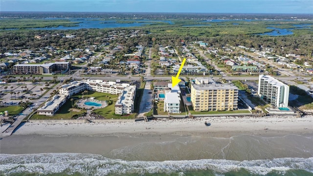 birds eye view of property with a beach view and a water view