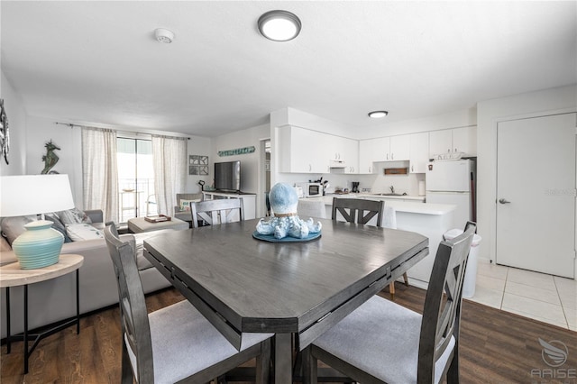 dining area featuring hardwood / wood-style floors and sink