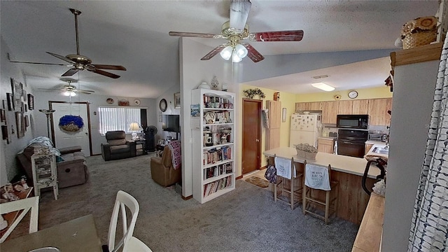 interior space with dark carpet, ceiling fan, a textured ceiling, and vaulted ceiling