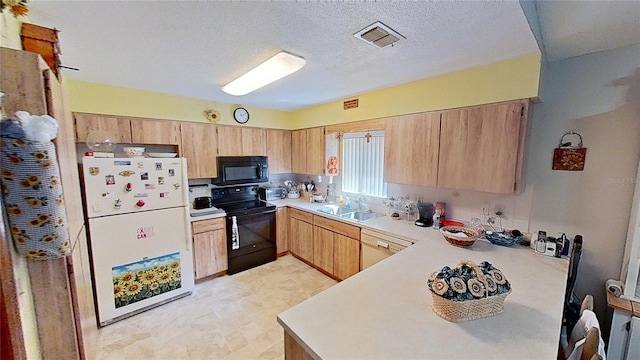 kitchen with light brown cabinetry, sink, black appliances, kitchen peninsula, and a textured ceiling