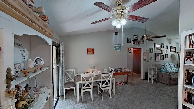 dining space featuring vaulted ceiling, a textured ceiling, ceiling fan, and carpet floors