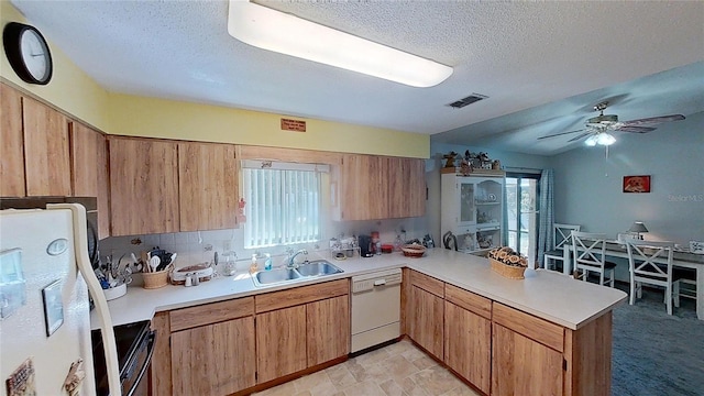 kitchen featuring plenty of natural light, kitchen peninsula, white appliances, and ceiling fan